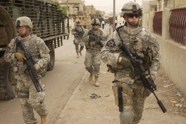 US Army soldiers move down a street as they start a clearing mission in Dora, Iraq, on May 3, 2007. Soldiers from the 2nd Platoon, Alpha Company, 2nd Battalion, 3rd Infantry Regiment, 3rd Stryker Brigade Combat Team, 2nd Infantry Division are patrolling the streets in Dora.