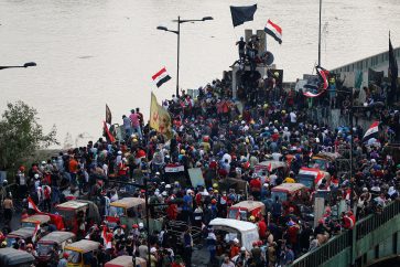 Demonstrators are seen at Al Jumhuriya bridge during a protest over corruption, lack of jobs, and poor services, in Baghdad