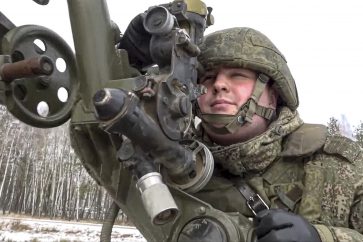 In this photo taken from video and released by the Russian Defense Ministry Press Service on Friday, Feb. 4, 2022, a soldier takes part in the Belarusian and Russian joint military drills at Brestsky firing range, Belarus. Russian and Belarus troops held joint combat training at firing ranges in Belarus. The drills involved motorized rifle, artillery and anti-tank missile units, as well tanks and armored personnel carriers crews. (Russian Defense Ministry Press Service via AP)