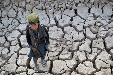 A child stands on a dry land in Bala Murghab district of Badghis province, Afghanistan, on Oct. 15, 2021.