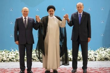 Russian President Vladimir Putin, left, Iranian President Ebrahim Raisi, center, and Turkish President Recep Tayyip Erdogan pose for a photo prior to their talks at the Saadabad palace, in Tehran, Iran, Iran, Tuesday, July 19, 2022. (Sergei Savostyanov, Sputnik, Kremlin Pool Photo via AP)