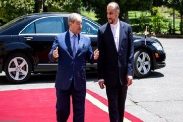 Iranian Foreign Minister Hossein Amir-Abdollahian welcoming Syrian counterpart Faisal Mekdad