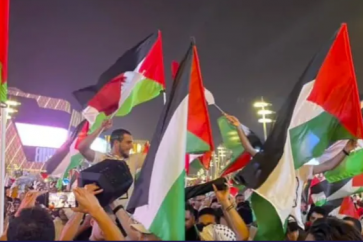 Arab fans raising Palestine's flag in Qatar