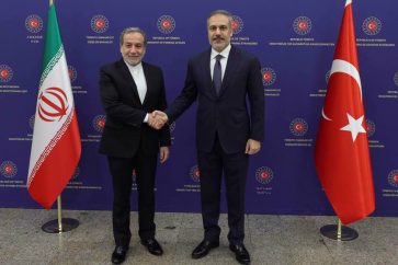 Iranian Foreign Minister Abbas Araghchi (L) shakes hands with his Turkish counterpart Hakan Fidan in Ankara