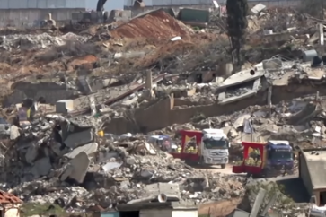 Trucks carrying bodies of 50 martyrs pass through Kfarkila streets filled with debris left by the Israeli war